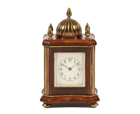 An Edwardian mahogany mantel clock, with brass dome and finials with two train spring driven movement striking on a gong and 