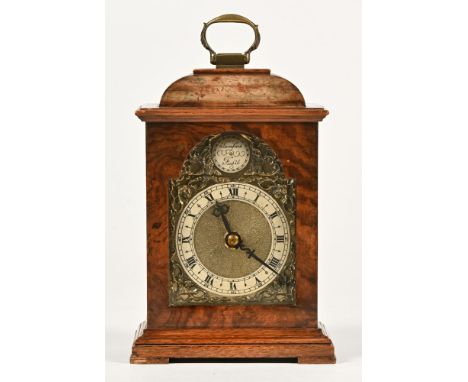 A small walnut cased George III style mantle clock.  Height excluding carrying handle 17 cm, width 11. 5 cm, depth 8 cm.