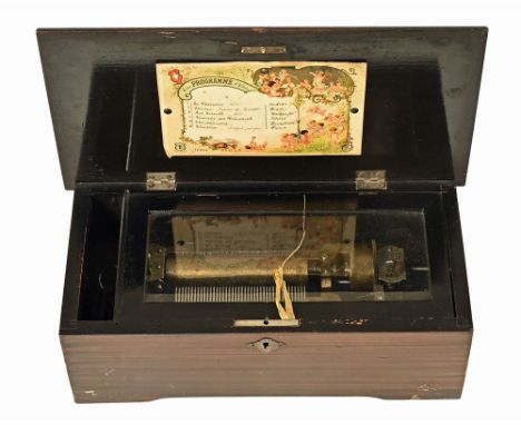 A Mermod Freres Swiss music box, circa 1900 and with a scumbled exterior opening to a black painted interior, the movement ma