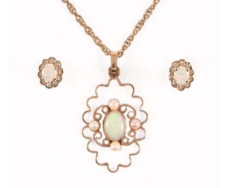 A 9 ct gold opal pendant on a yellow metal 22" chain, with matching 9 ct gold earrings (see illustration).