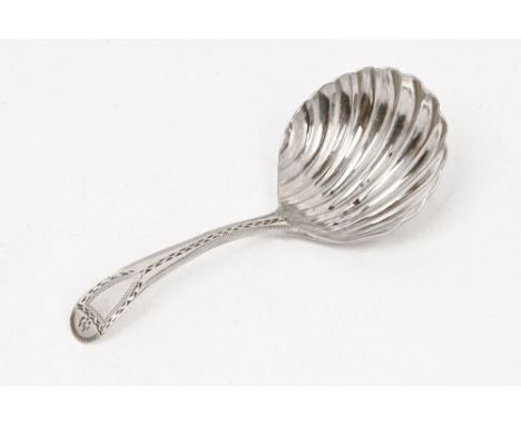 A Georgian silver caddy spoon, with shell shaped bowl, marked to rear with date letter H a lion and the initials IL.  Weight 