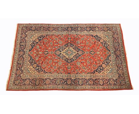 A Persian Kashan wool carpet, with red and blue decoration.  303 x 210 cm.