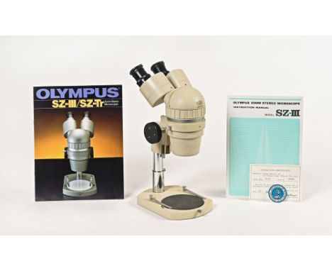 An Olympus Tokyo zoom stereo microscope, with instruction manual.  Serial No. 326426.