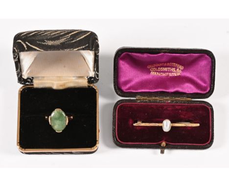 A jade ring, in 14 ct gold shank, together with a gold coloured metal bar brooch with mother of pearl.