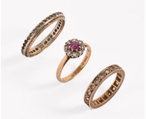 An 18 ct gold diamond and ruby ring.  Size K and two eternity rings, one marked 9 ct.  Size K and Size R.  weight 7.5 grams.