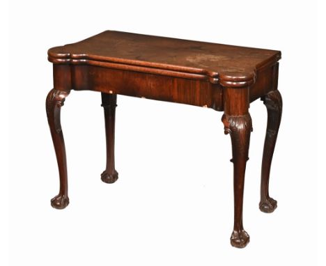 A Georgian mahogany turnover top card table, with shaped edge the top opening to a green baize fitted interior with dished co