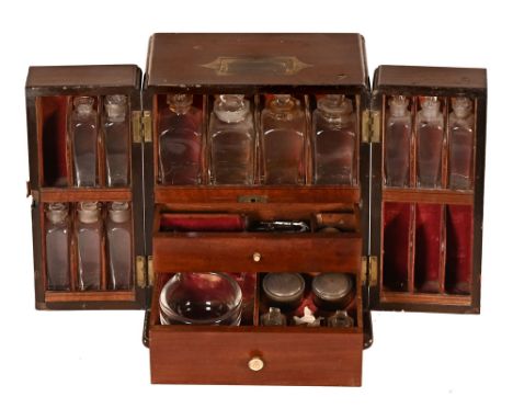 A George III mahogany apothecary cabinet, with brass handle to the lid with a pair of drawers opening to a fitted interior wi