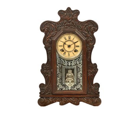 An Ansonia Clock Company New York mantel clock, with carved wooden case and two train spring driven movement striking on a go