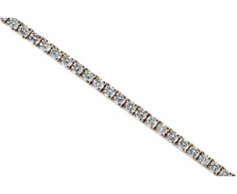 An 18 ct yellow gold diamond tennis bracelet, containing 3 carats of diamonds.  Length 18 cm.