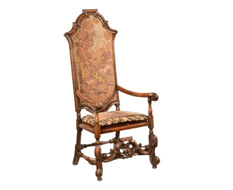 A continental high backed carver chair, the back with shaped decoration and with tapestry hunting scene, the base with tapest