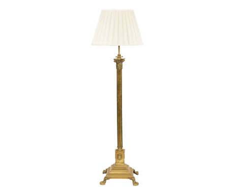 A brass Corinthian column lamp standard, with cream shade and raised on hairy paw feet.  Column height excluding electrical f
