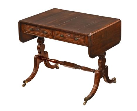 A Regency rosewood sofa table, with twin drop flaps fitted with two frieze drawers and two opposing dummy drawers with silhou