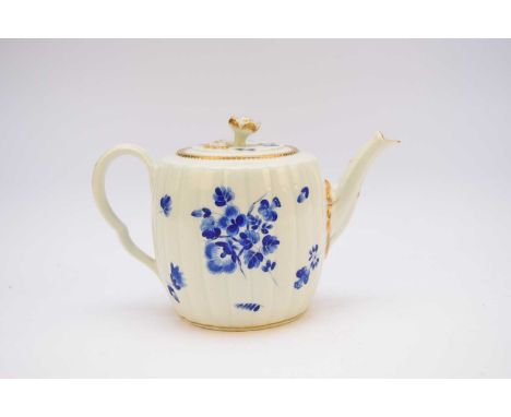 A Worcester 'dry-blue' floral teapot and cover, circa 1765, of barrel, fluted form, painted with floral bouquets and scattere