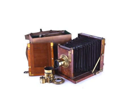 A late 19th century mahogany full plate field camera by G.Hare, numbered 7446, circa 1880 with three plate holders, one quart