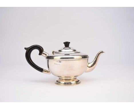 A silver teapot, Marson &amp; Jones, Birmingham 1932, of circular form with ebony handle and finial, 12.5cm high, weight appr