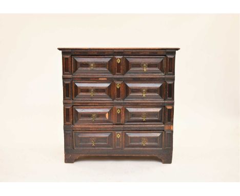 An oak geometric fronted chest of drawers, circa 1700, in two parts, the plain boarded top above four long mitre-moulded draw