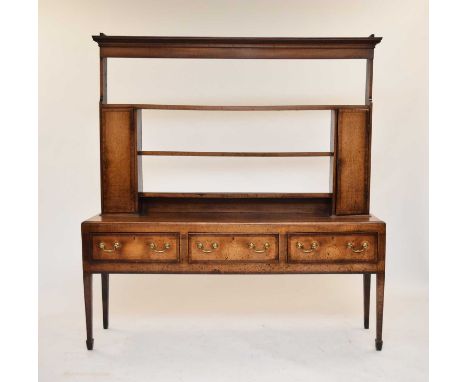 A late 18th century cross-banded oak dresser and rack, the dentil cornice above three shelves, the lower two flanked by spice
