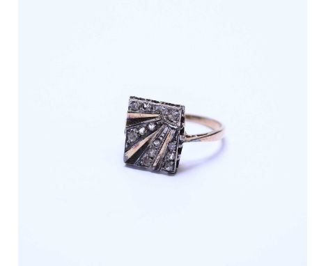 An Art Deco style paste set dress ring, the rectangular plaque with radiating stylised sunburst design, the yellow metal shan