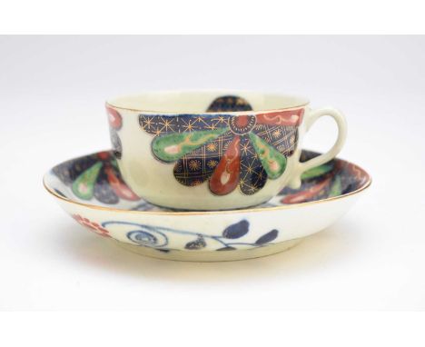 A Worcester 'Japan Fan' teacup and saucer, circa 1770, brightly decorated in the Imari palette with gilt flower within a blue