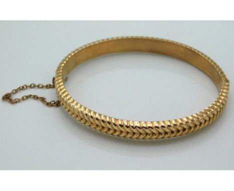 A 9ct gold bangle, internal 58mm diameter, 9.8g