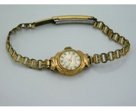 An 18ct gold cased ladies 21 ruby movement wristwatch with plated strap