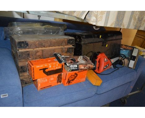 A WOODEN BOX, containing hand tools, a Stanley 130 plane, a tin trunk, three boxed drill attachments, a Black and Decker Reci