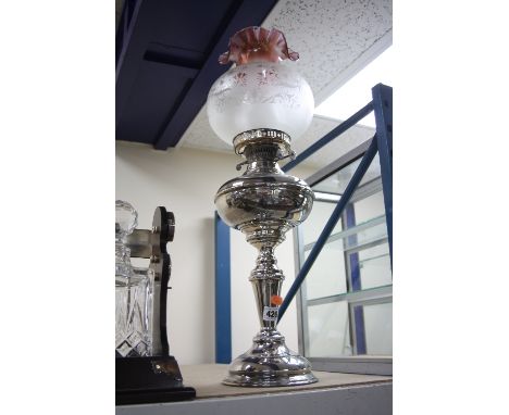 A SILVER PLATED OIL LAMP, with amethyst and opaque glass shade