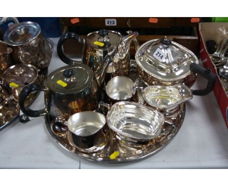A FOUR PIECE ELKINGTON PLATED TEA SERVICE, together with a three piece Elkington tea service and a circular tray