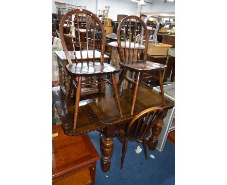 AN OAK CROSS STRETCHERED DRAW LEAF DINING TABLE, and four Ercol chairs (sd) (5)