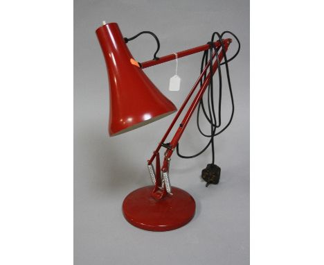 A RED ANGLE-POISE LAMP