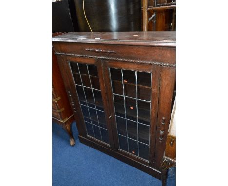 AN OAK LEAD GLAZED TWO DOOR BOOKCASE and a standard lamp (key) (2)