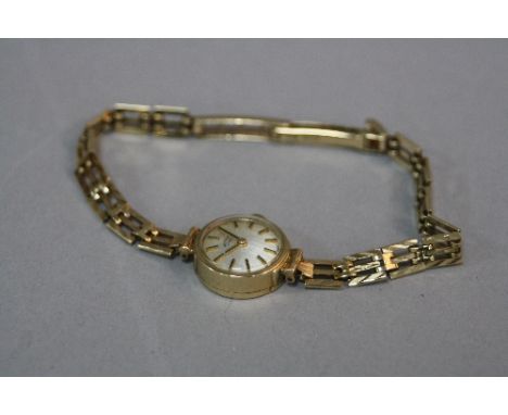 A  MID - LATE 20TH CENTURY 9CT GOLD LADIES ROTARY WRIST WATCH, silver dial with gilt baton markers and hands, mechanical move