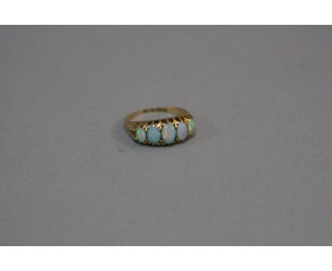 AN EARLY 20TH CENTURY 18CT GOLD FIVE STONE GRADUATED OPAL HALF HOOP RING, white opals with a strong predominate bluish green 