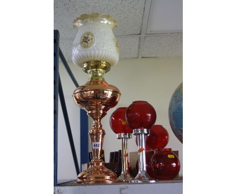 A VICTORIAN STYLE COPPER BASED OIL LAMP WITH GLASS SHADE, together with another pair of lamps and coloured glass shades