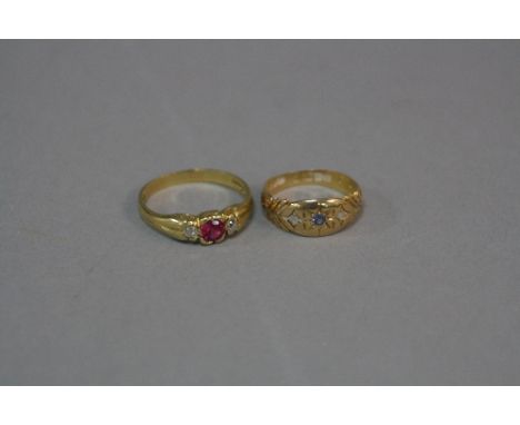 TWO EARLY 20TH CENTURY DRESS RINGS, an 18ct gold three stone diamond and synthetic ruby ring, two old swiss cut diamonds, est