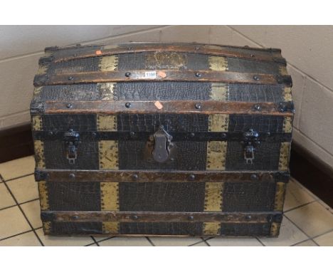 A 20TH CENTURY DOMED TOPPED TRUNK, with metal banding and embossed simulated crocodile covering