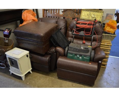 A BROWN LEATHER RECLINING ARMCHAIR, another leather reclining armchair (broken mechanism) and a brown leather pouffe (3)