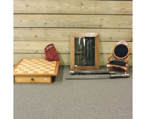 A chess set, together with two others, a doll's armchair and button hooks in a display frame