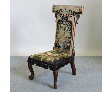 A Victorian rosewood prie dieu, with tapestry upholstery