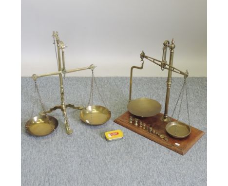 A set of brass scales and weights, 52cm tall, together with another smaller