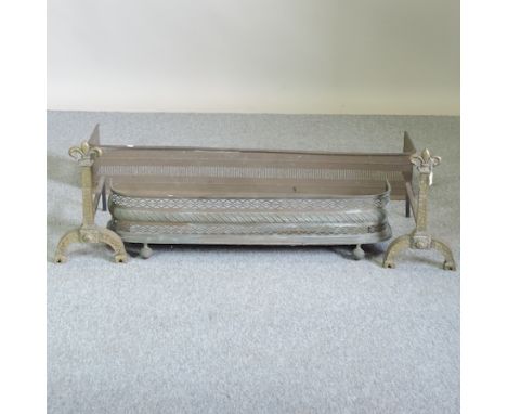 A 19th century brass fender, 132cm wide, together with another smaller and a set of fire tools