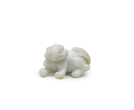 A PALE GREEN JADE CARVING OF A BUDDHIST LION19th century The beast carved recumbent with a joyful expression defined by bulgi