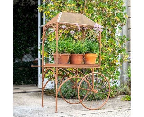PLANT STAND, 152cm x 98cm x 70cm, in the form of a vintage cart, aged metal finish. 