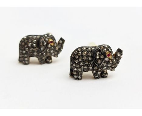 PAIR OF ELEPHANT SHAPED CUFFLINKS, set with rose-cut diamonds and ruby set eyes, gold plated Diamonds 1.12ct. Round-cut rubie