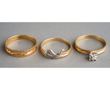Trio of yellow metal rings, centre ring marked for 14 ct, gross weight 3.5g 