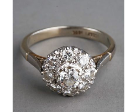 An 18ct white gold and diamond cluster ring, the centre diamond approx 0.2ct within a border of smaller diamonds, size N1/2, 