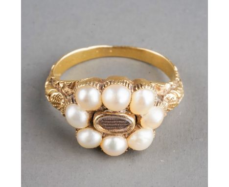 A 19th century gold and pearl mourning ring, set with eight pearls surrounding a plait of hair, chased foliate shoulders, ins