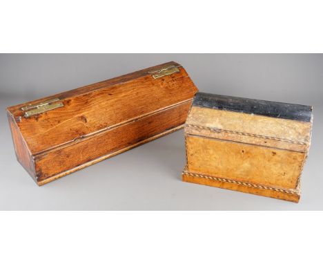 An early 19th century oak and stained pine candle box of rectangular form with sloped hinged lid and open to one side, fitted