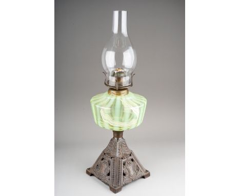 Oil lamp, Vaseline glass font and a cast iron base.  Glass chimney but lacks a shade.  50cm tall including the chimney 