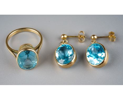 A yellow gold and blue topaz ring, size M, approx 3.9g; together with a pair of earrings, post and butterfly fittings, approx